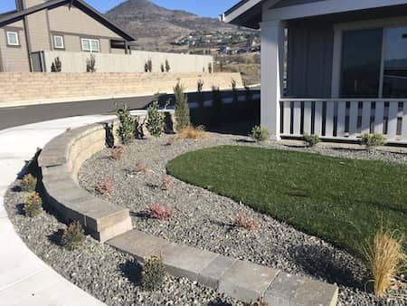 Natural rock retaining wall in front yard