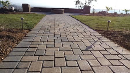 Paver walk way with fire place in backyard in Medford