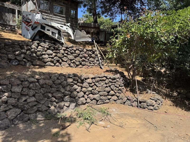 After photo is 2 layer retaining wall of natural rock 