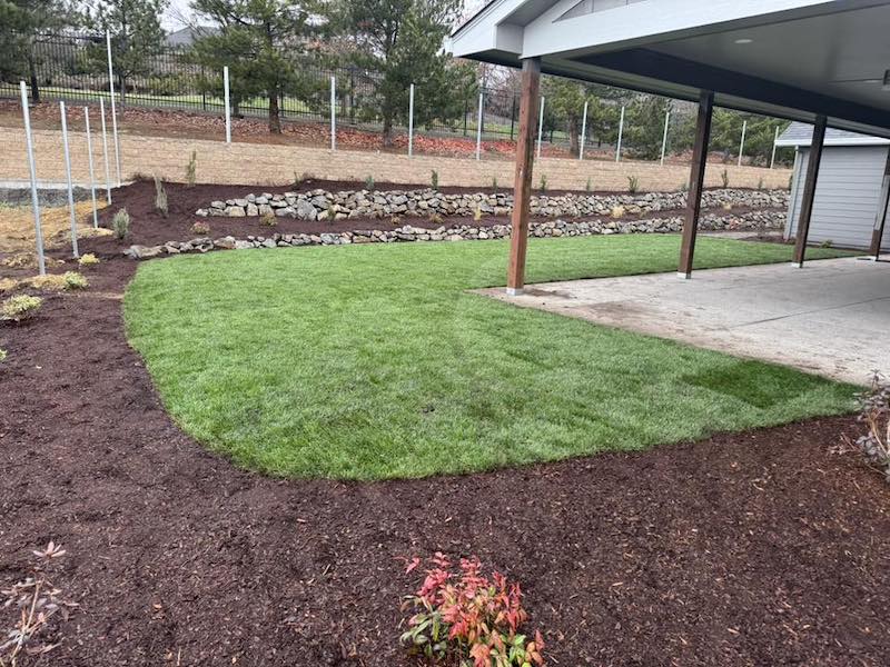 Sod, irrigation and natural rock retaining wall