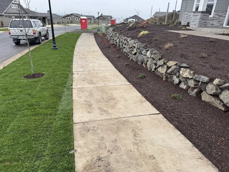 Front Yar WithWith Sod, Irrigation, And Retaining Wall