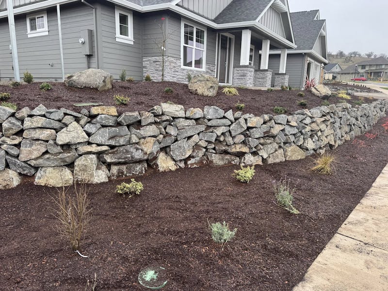 Front yard with natural stone retaining wall