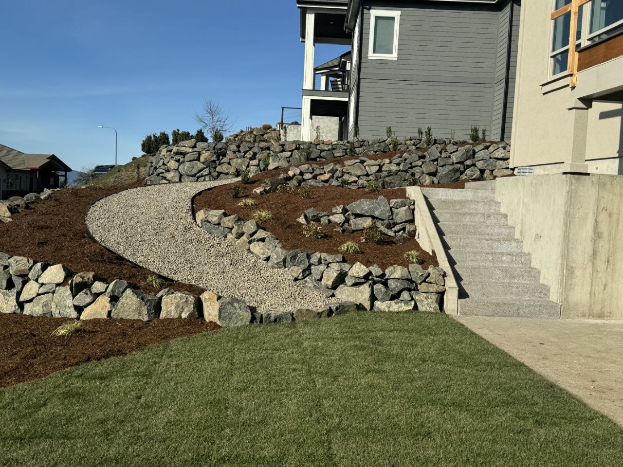 Front yard with multiple natural stone retaining wall